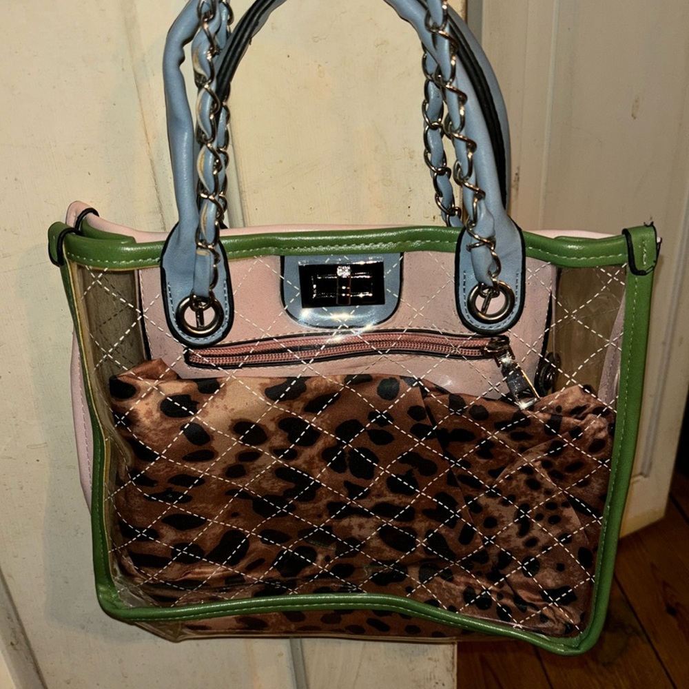 Clear ladies shoulder bag with pink, blue and green trim. Animal print inner bag